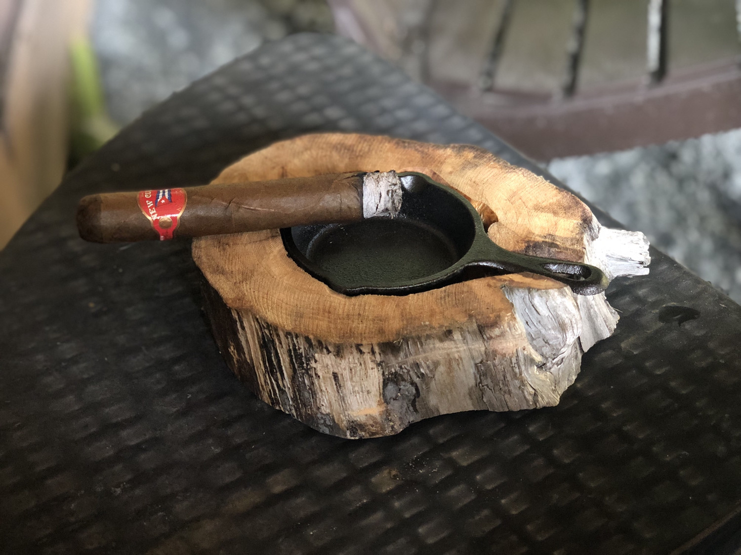 Free handed cigar ash tray. Iron skillet and a river log.